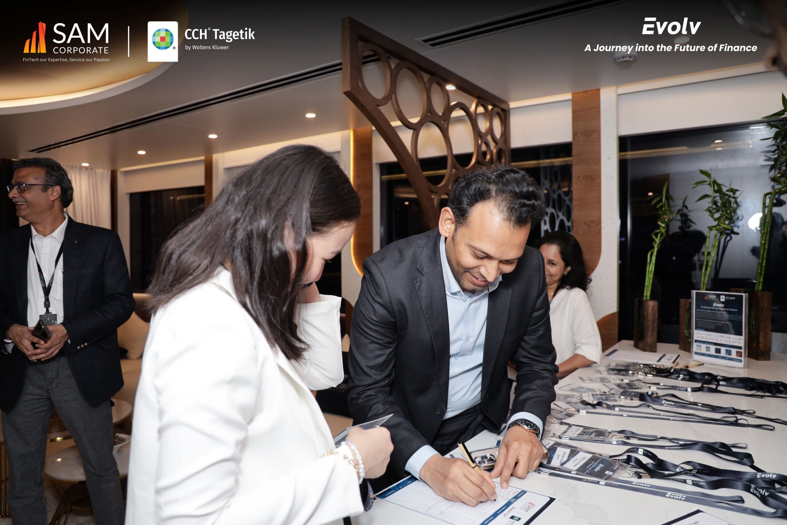 Guests signing in at the registration desk for the Evolv event, organized by SAM Corporate and featuring CCH Tagetik.