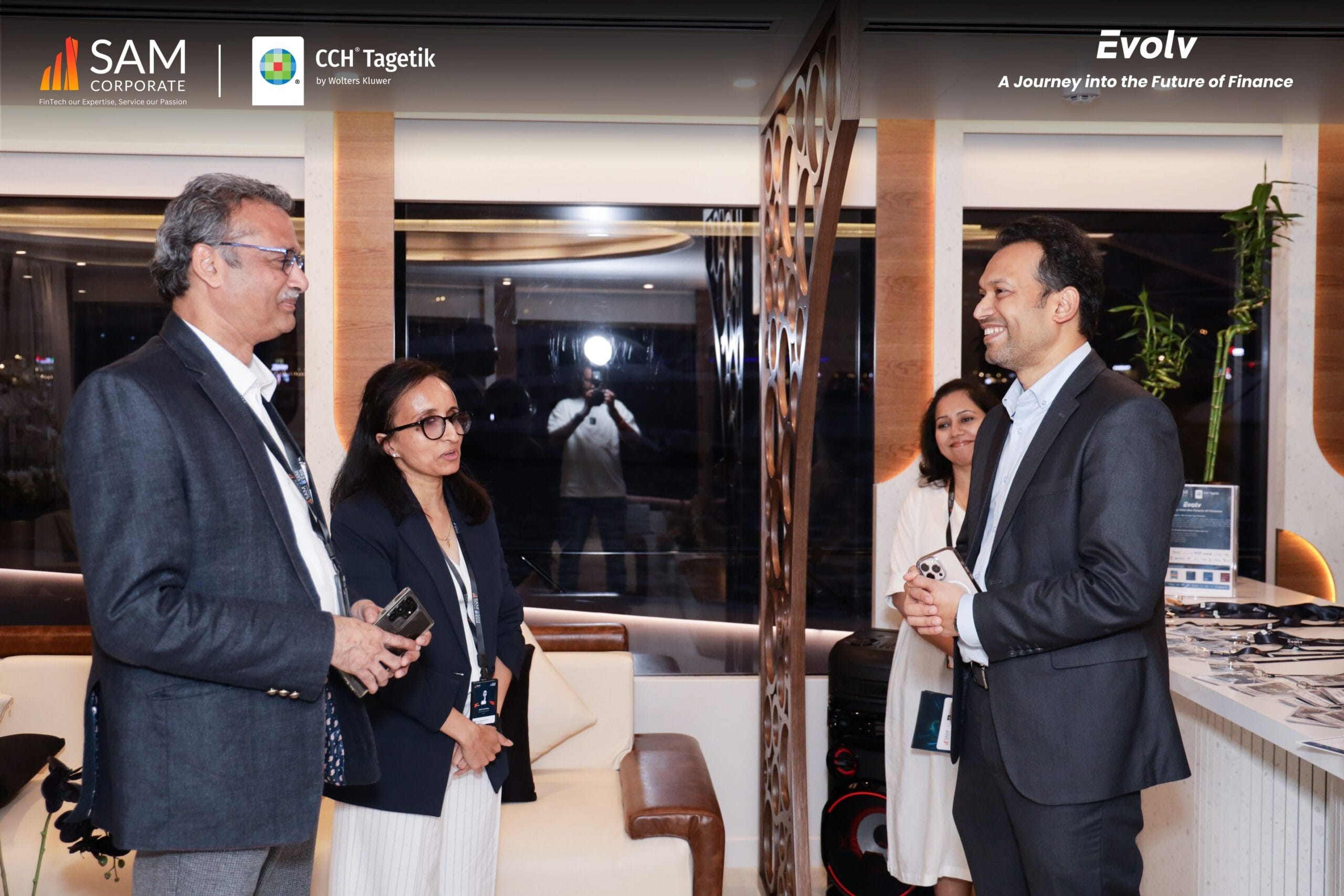 Business professionals engaging in conversation at the Evolv event, co-hosted by SAM Corporate and CCH Tagetik.