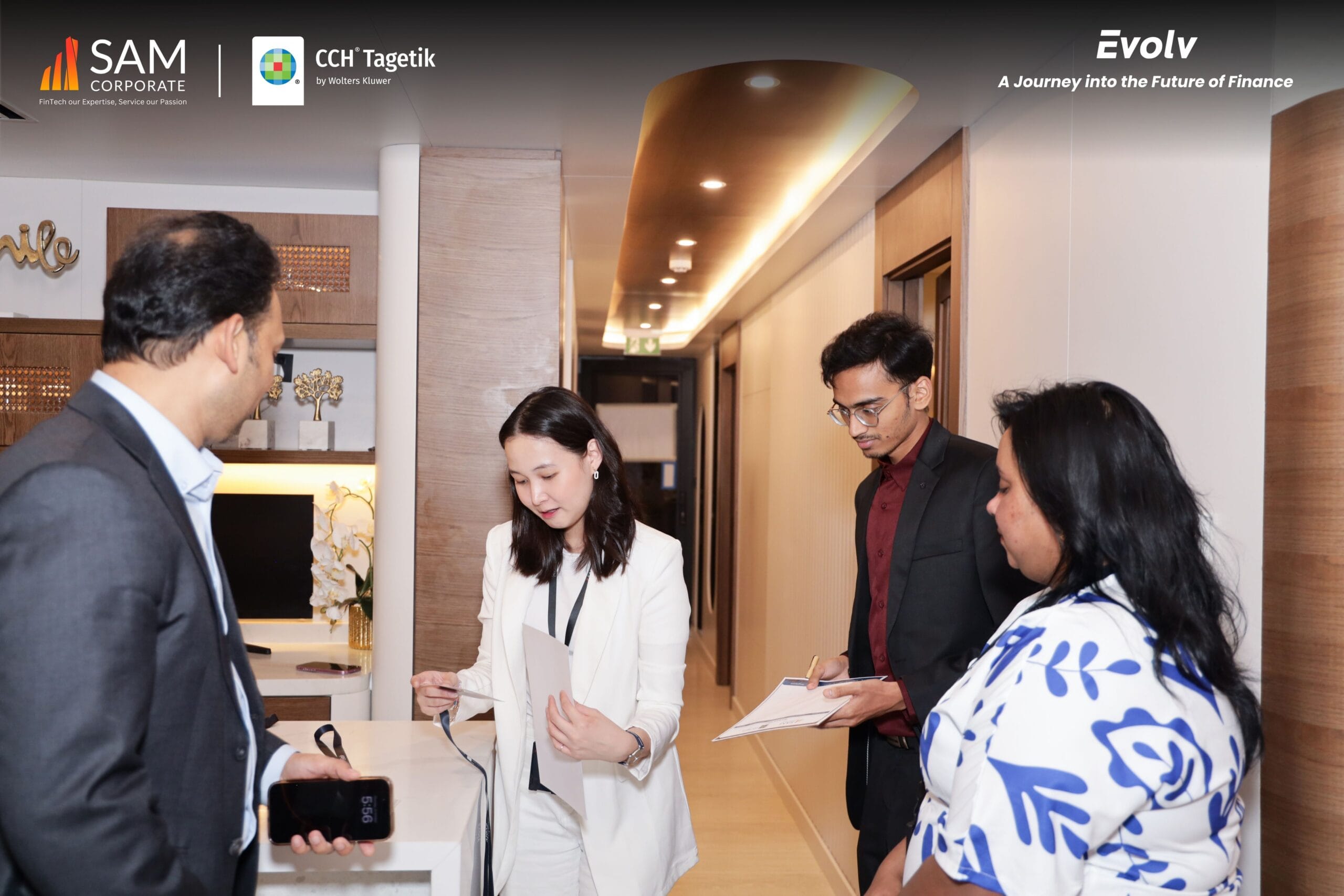 Registration and check-in area at the Evolv event with attendees and staff, highlighting the SAM Corporate and CCH Tagetik partnership.