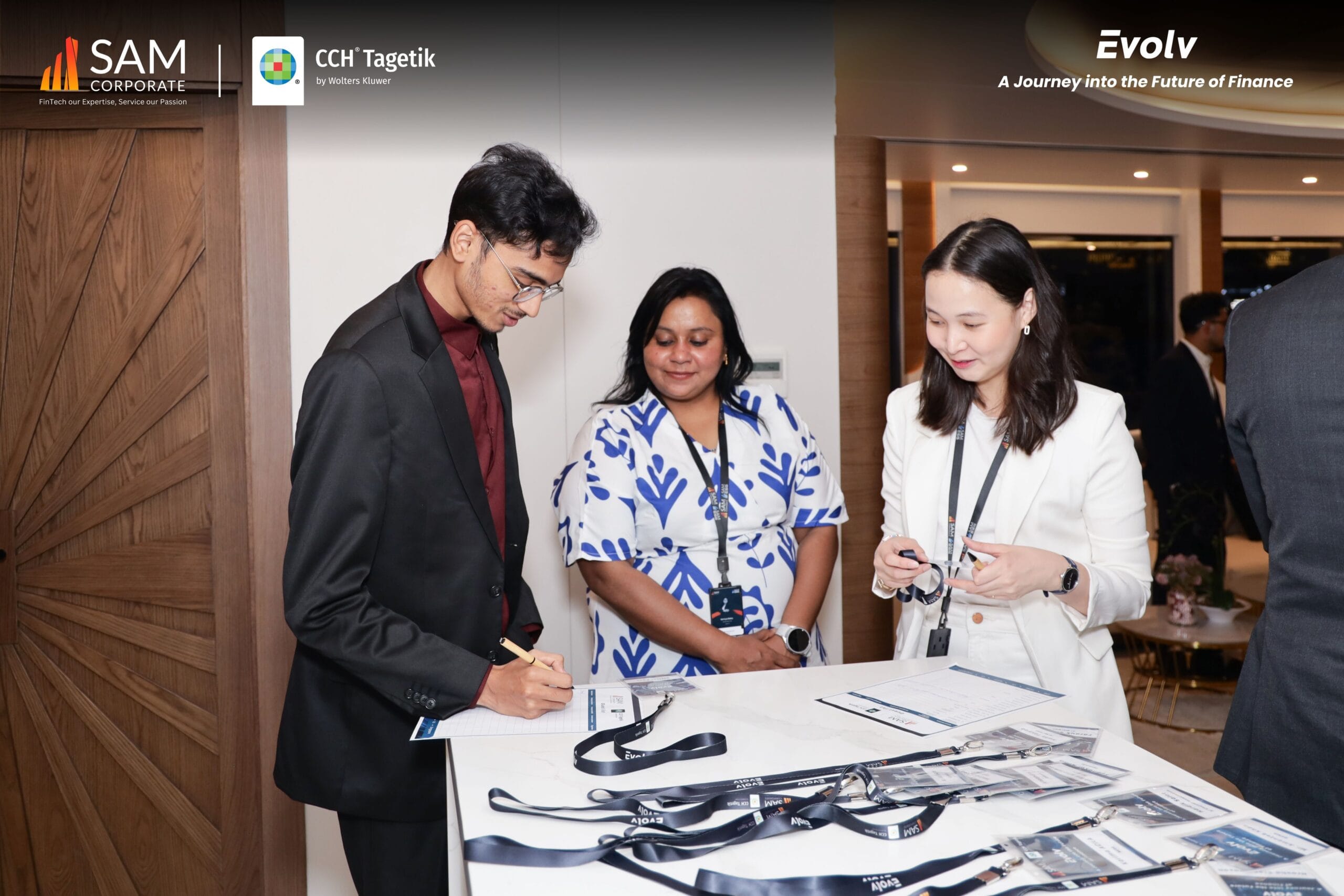 Attendee signing in at the registration desk for the Evolv event, sponsored by SAM Corporate and CCH Tagetik.