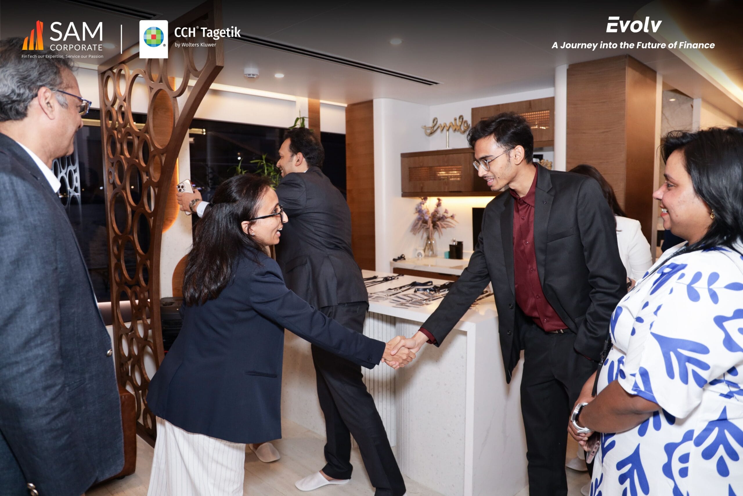 Attendees greeting each other indoors at the Evolv networking function, an initiative by SAM Corporate and CCH Tagetik.