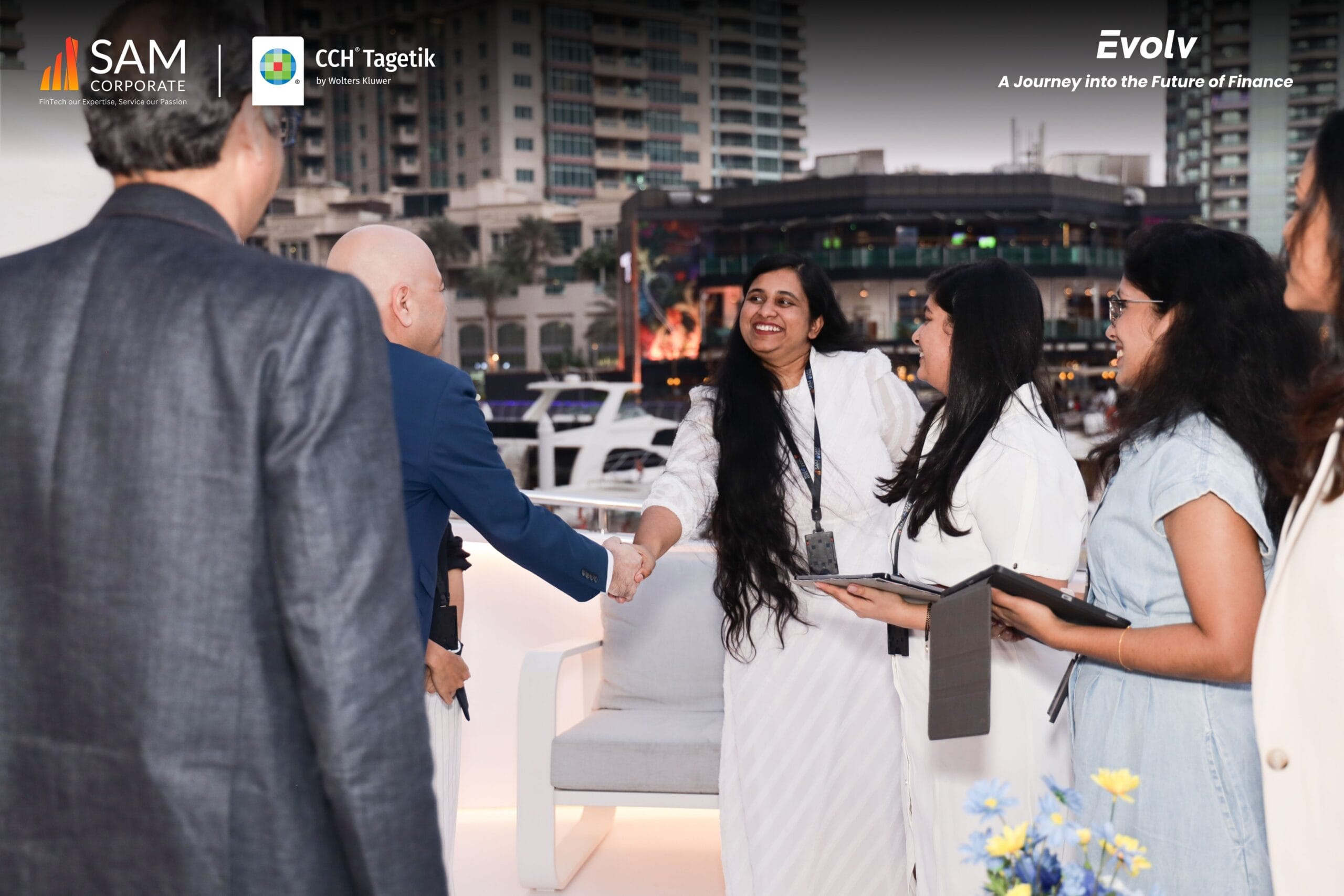 Evolv event guests networking and shaking hands on the SAM Corporate CCH Tagetik yacht deck.