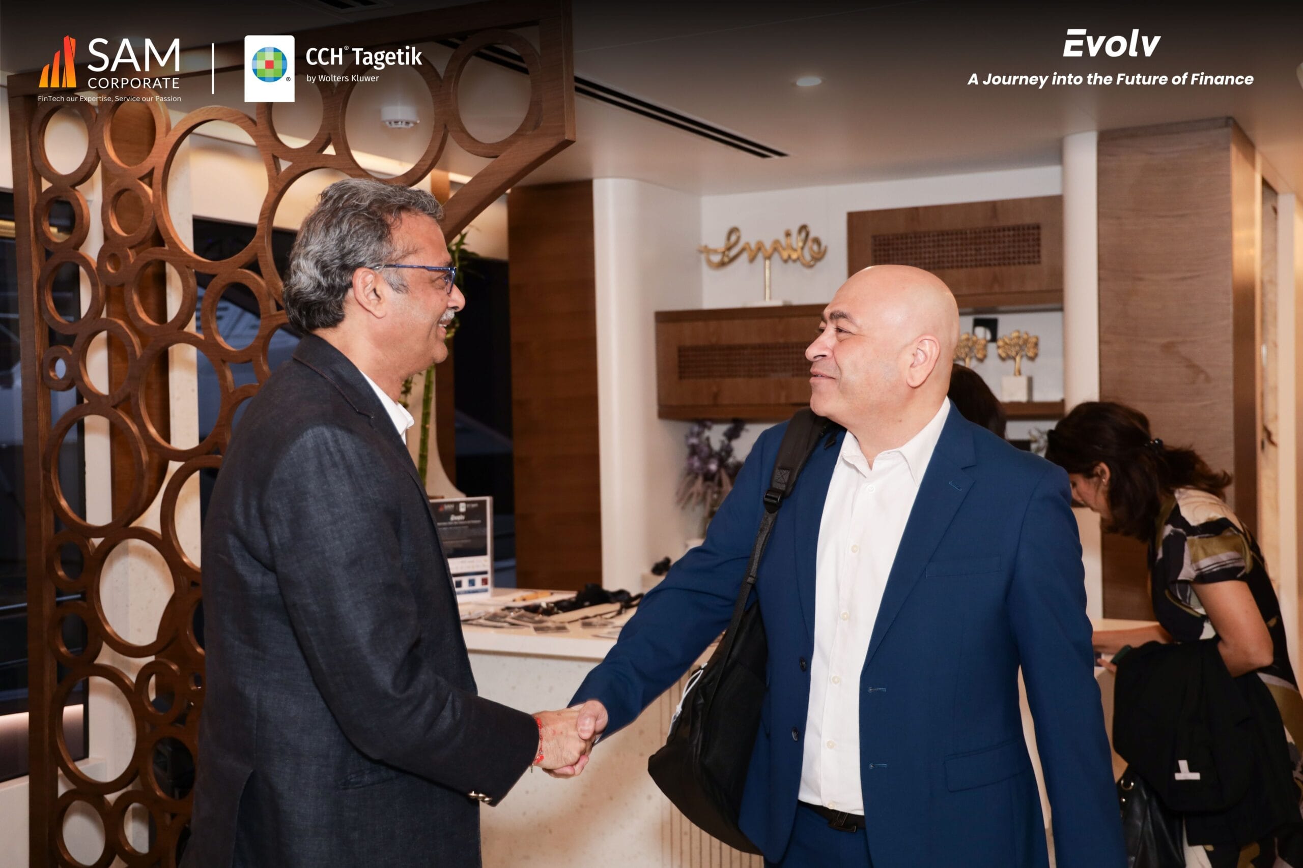 SAM Corporate CCH Tagetik Evolv event guests networking and shaking hands in the yacht lounge.