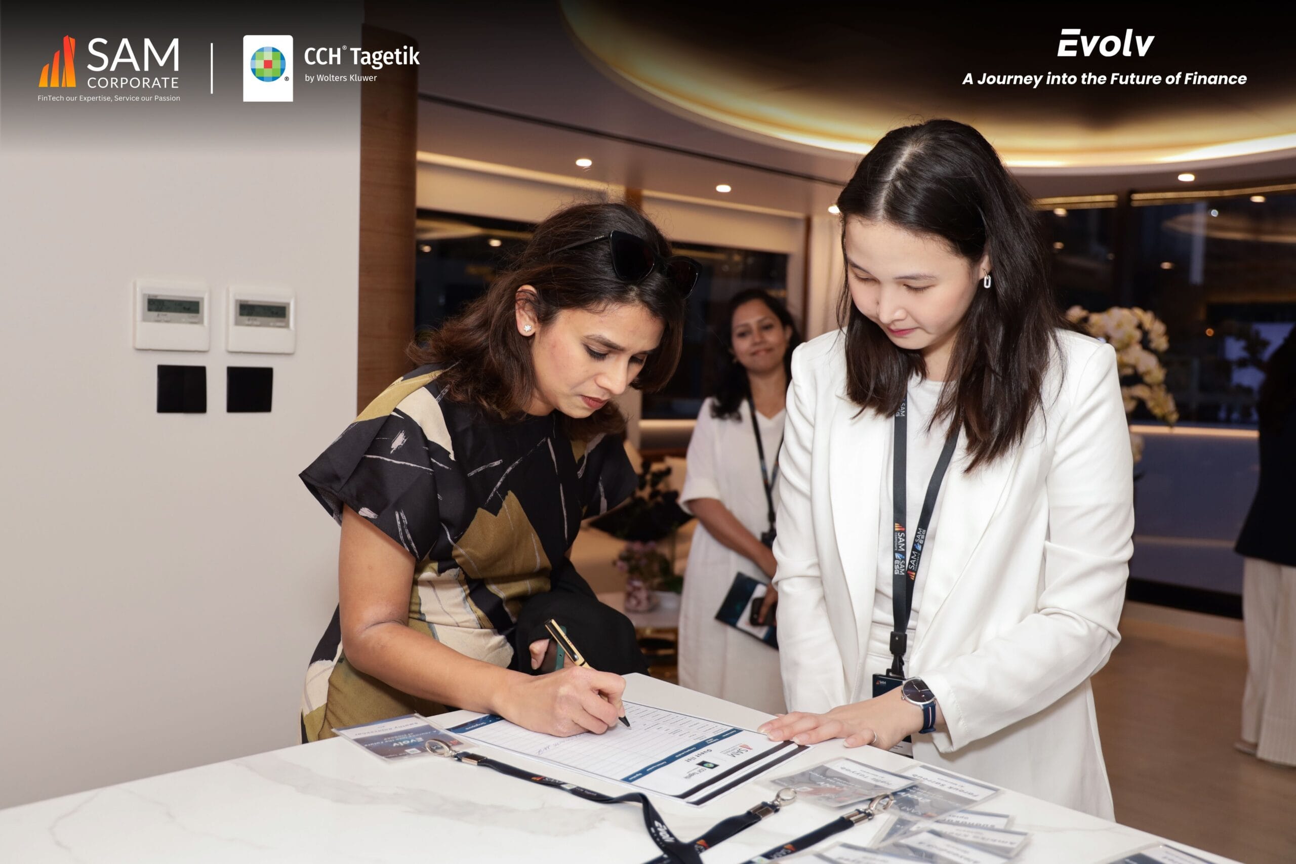 An attendee completing registration for the Evolv event, powered by SAM Corporate and CCH Tagetik, set on a luxurious yacht.