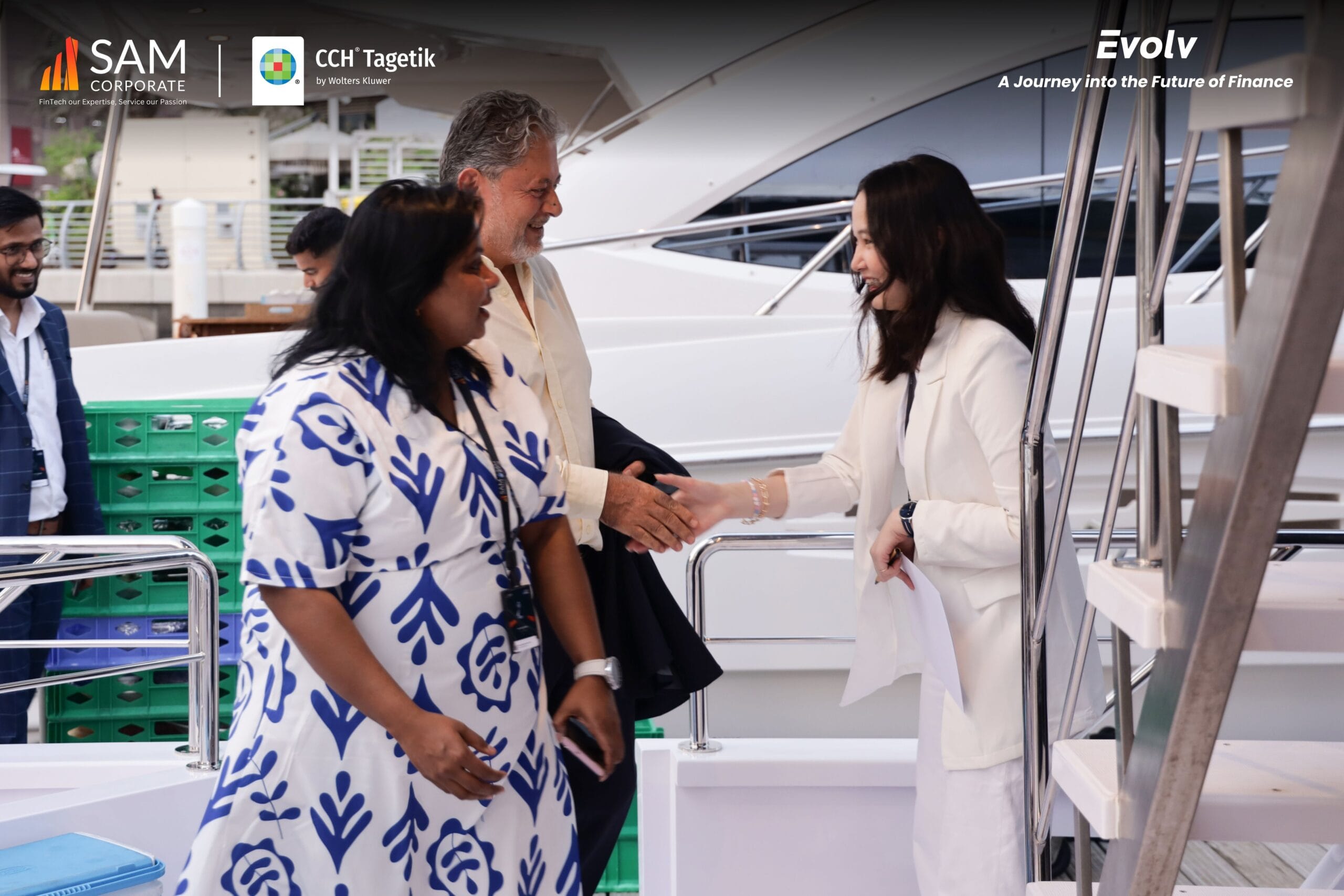 SAM Corporate CCH Tagetik Evolv finance event guest handshake on luxury yacht deck.