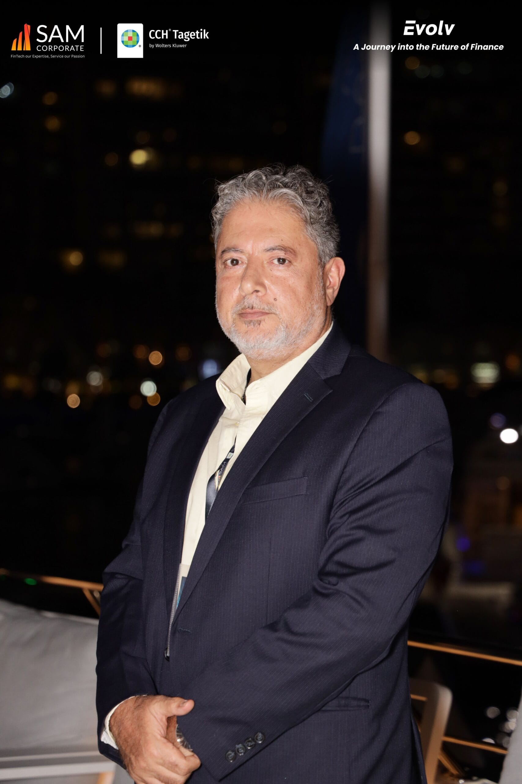 A key speaker or representative from SAM Corporate or CCH Tagetik posing for a portrait at the Evolv night networking event.