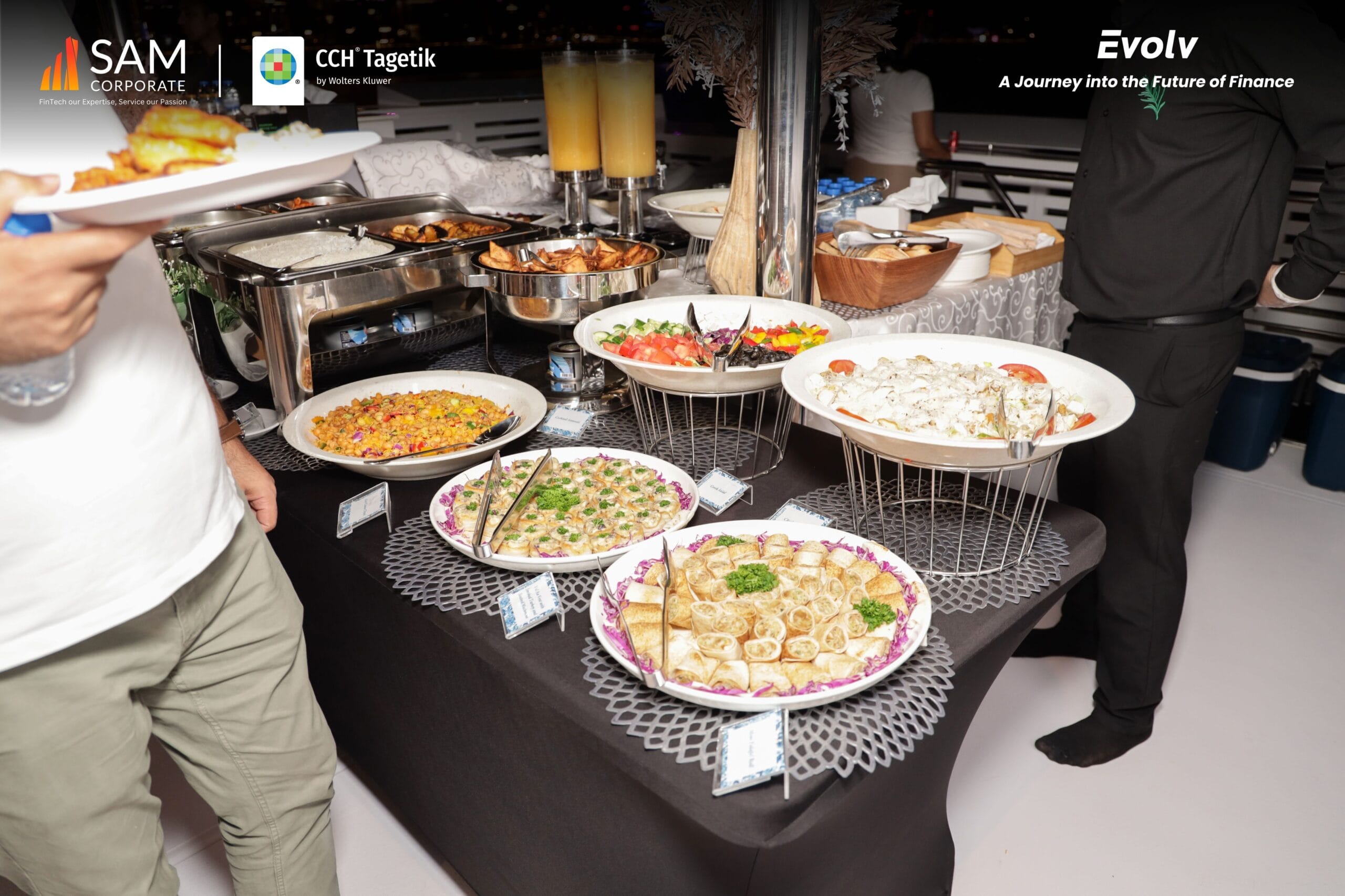 A buffet spread featuring salads and appetizers at the Evolv networking event hosted by SAM Corporate and CCH Tagetik.