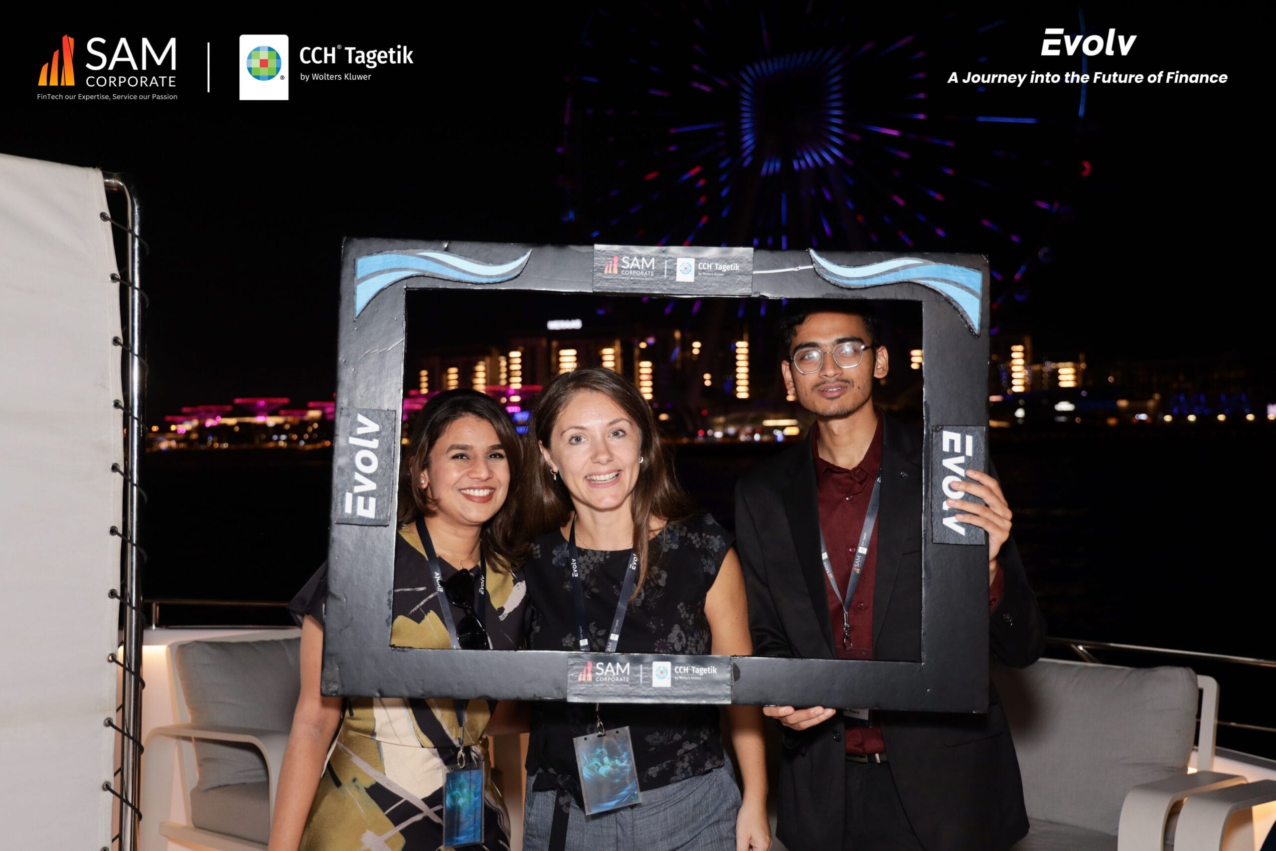 Attendees posing in a photo booth on the yacht deck during the Evolv event by SAM Corporate and CCH Tagetik.