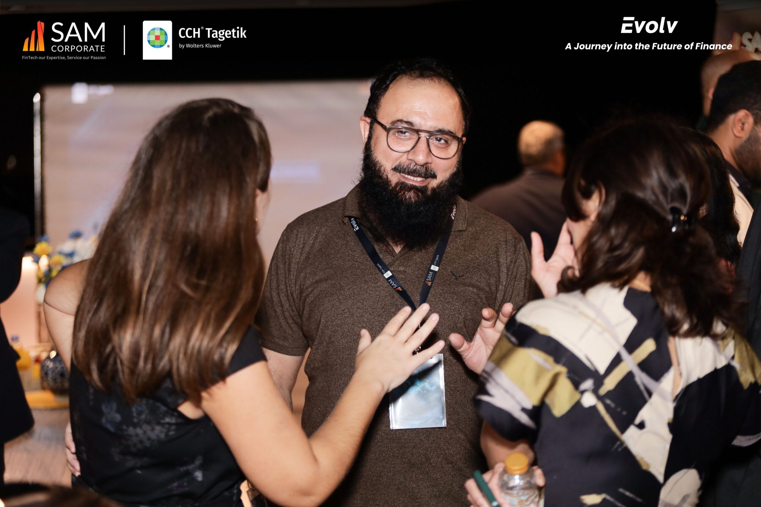 SAM Corporate and CCH Tagetik executives and guests networking in a lively conversation at the Evolv event.