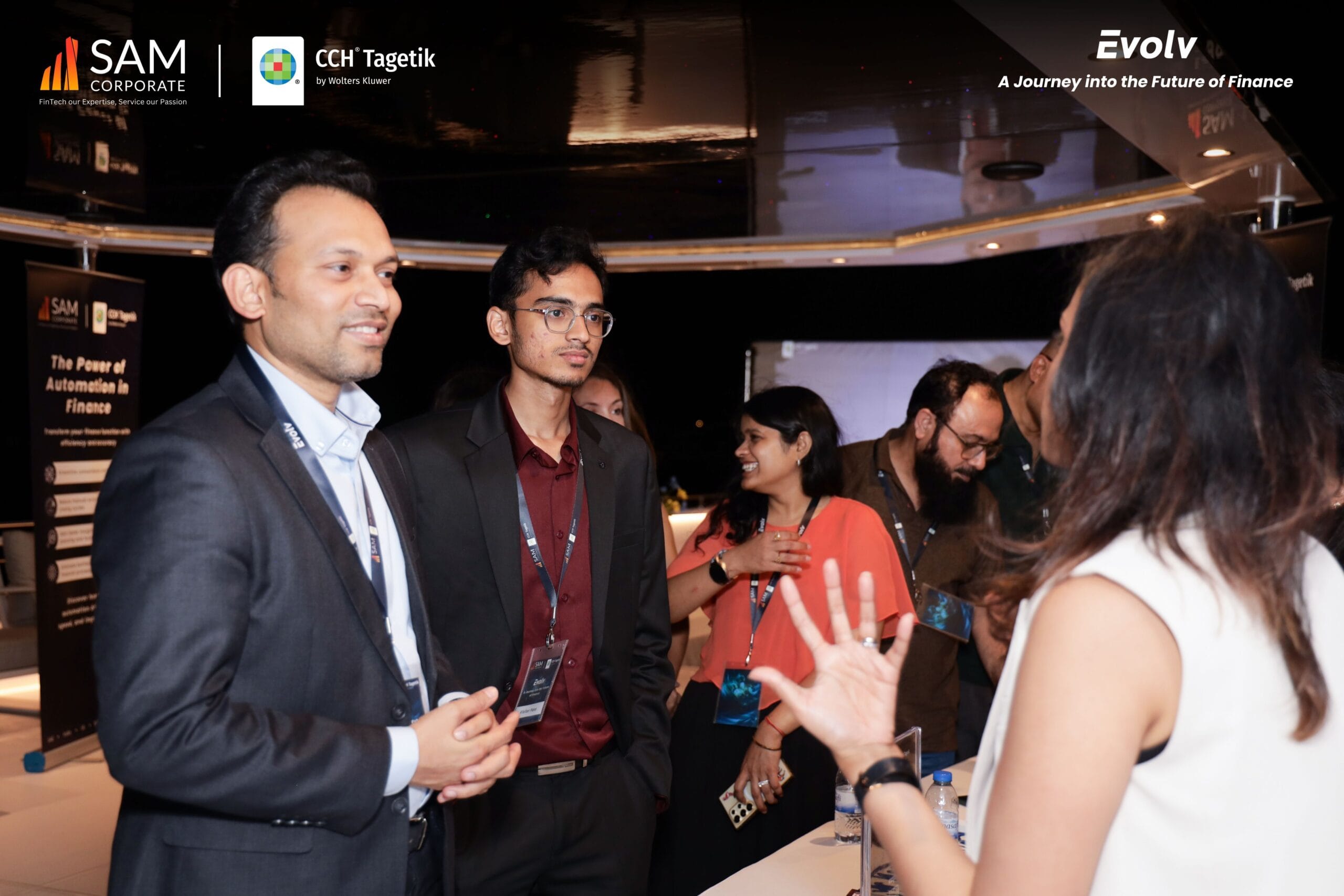 SAM Corporate and CCH Tagetik guests engaged in a professional discussion during the Evolv networking event.