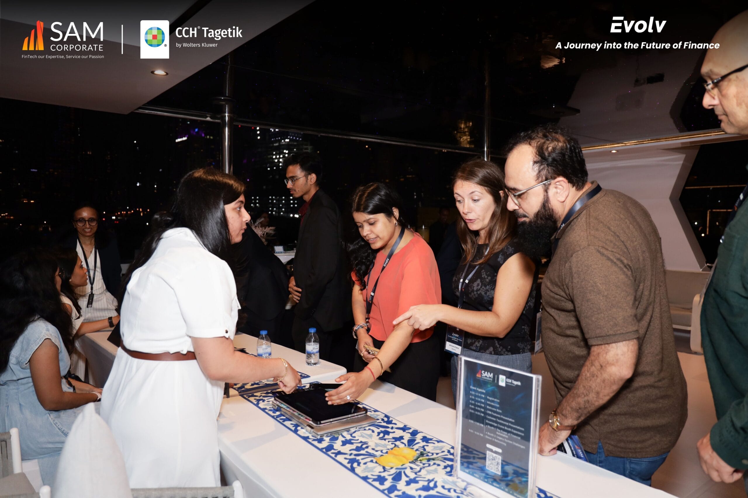 SAM Corporate and CCH Tagetik executives and guests reviewing materials at a discussion point during the Evolv networking event.