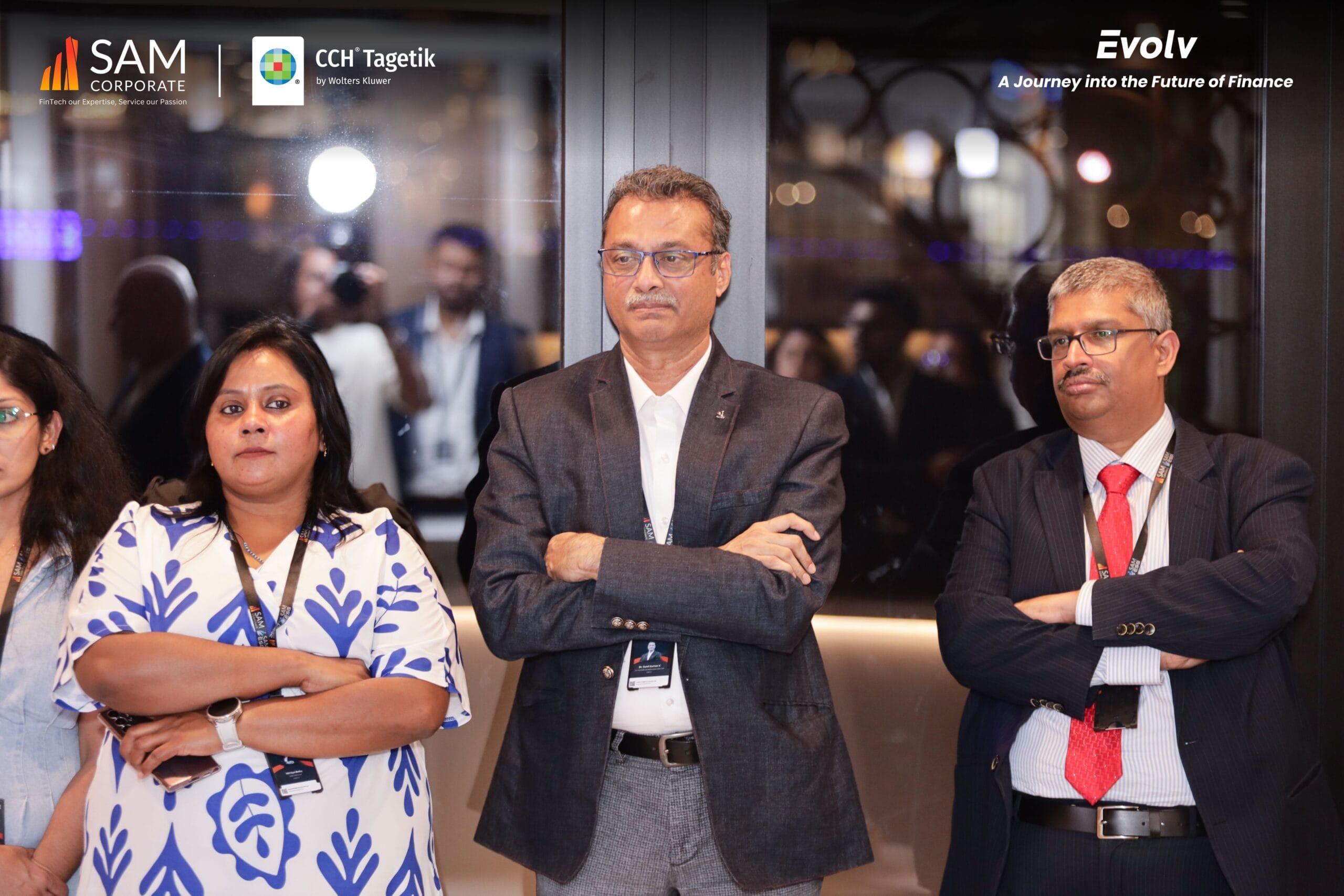 Group of male and female finance executives standing with arms crossed, listening intently at the Evolv event by SAM Corporate and CCH Tagetik.