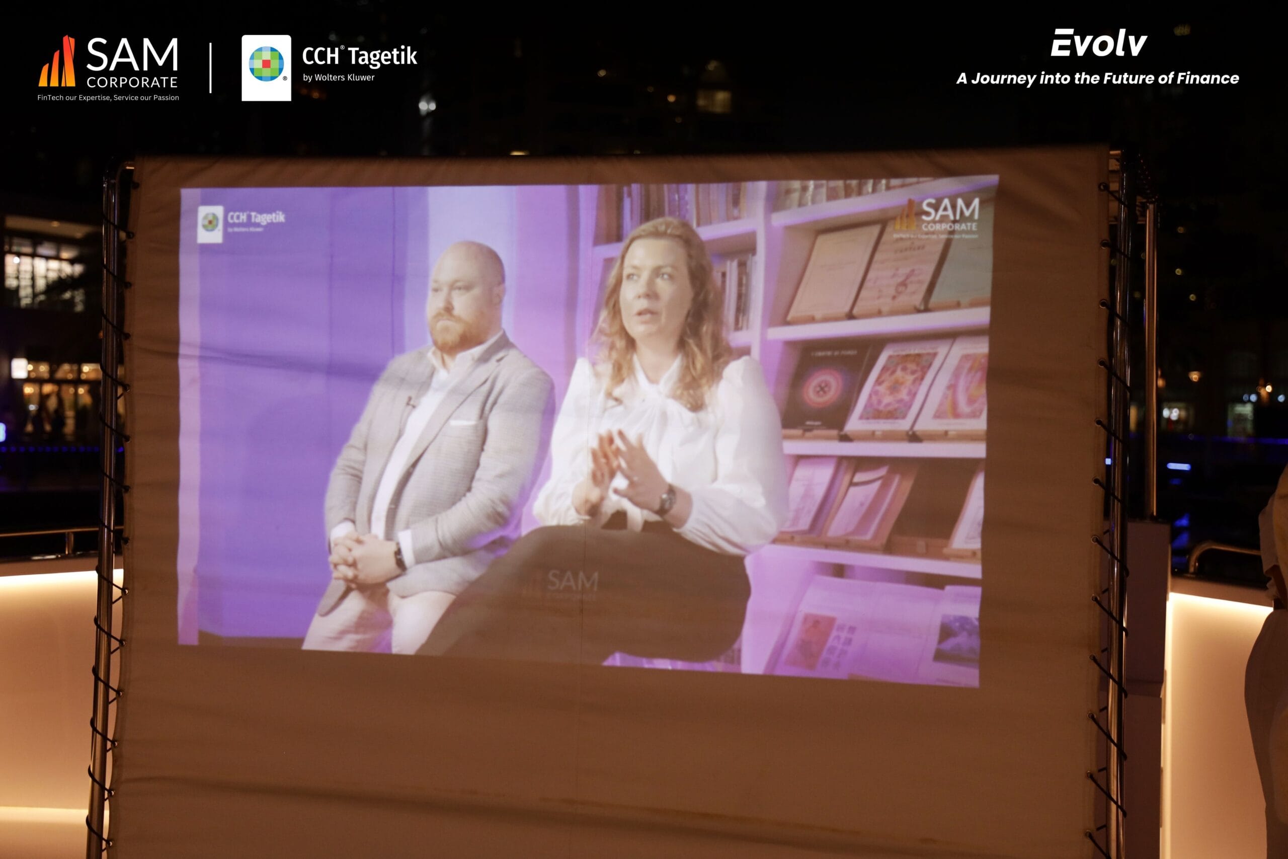 Virtual presentation screen showing two speakers at the Evolv event sponsored by SAM Corporate and CCH Tagetik.