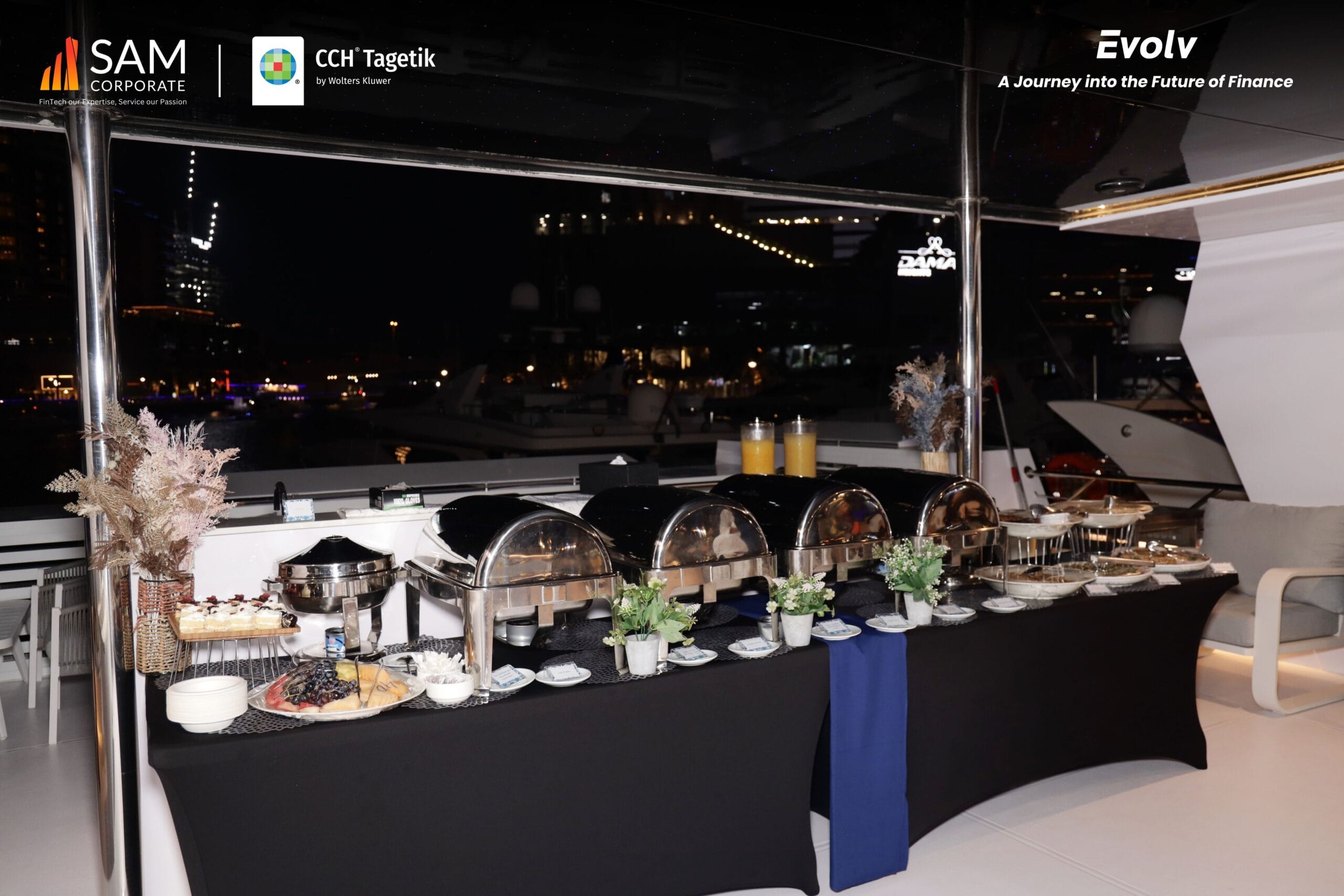Elegant buffet and dinner setup on the deck of the yacht during the Evolv networking event by SAM Corporate and CCH Tagetik.
