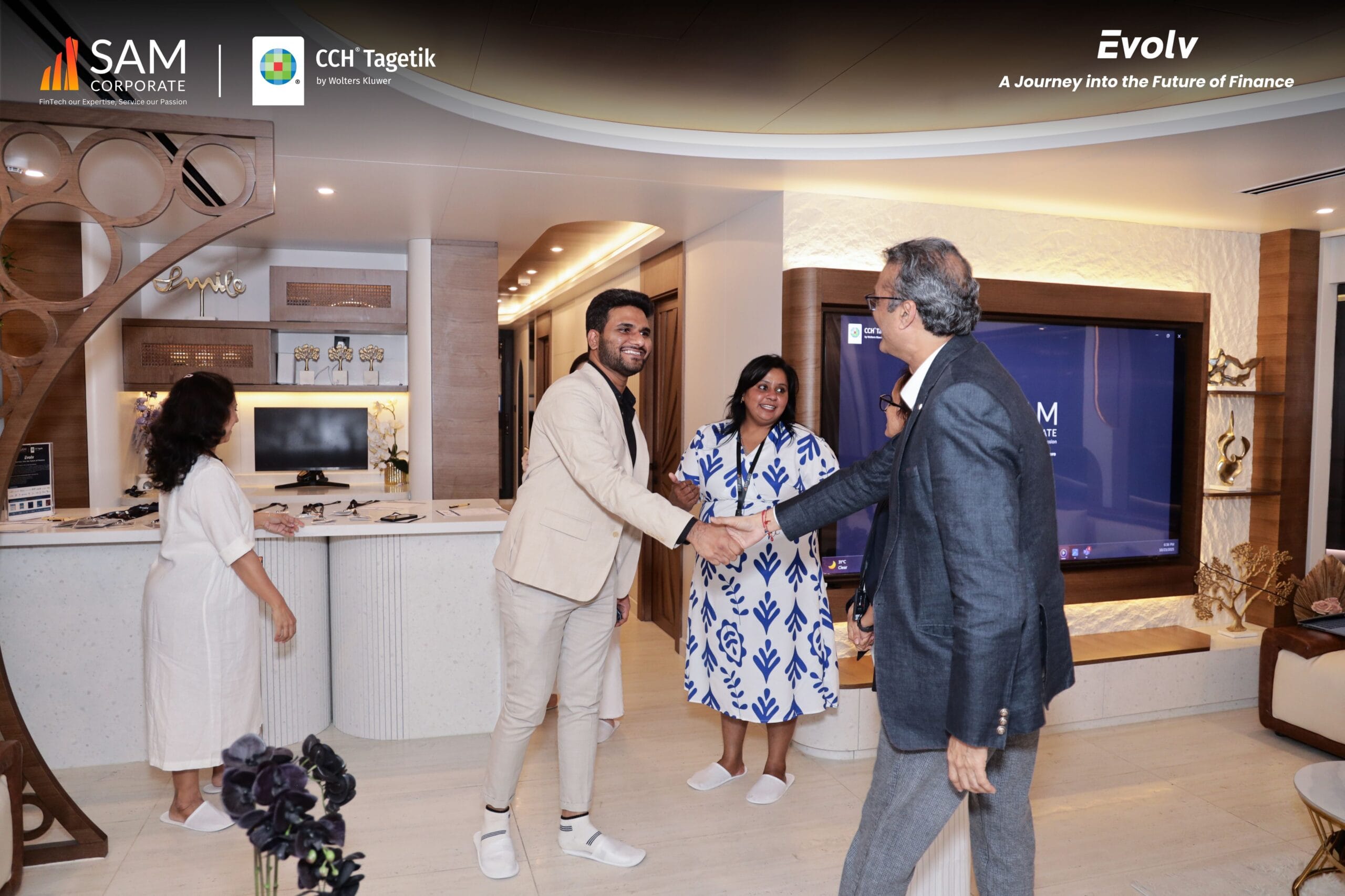 Two business leaders shaking hands upon arrival at the Evolv event, an exclusive summit by SAM Corporate and CCH Tagetik.