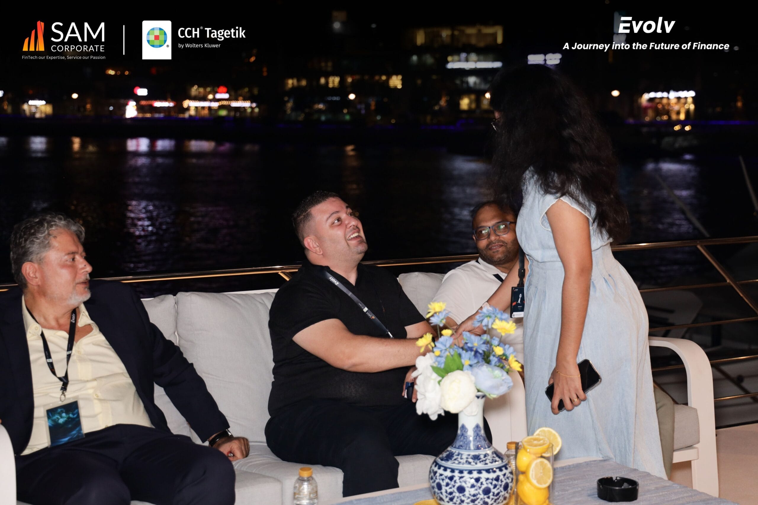 Attendees engaging in a lively conversation on the outdoor deck during the Evolv event by SAM Corporate and CCH Tagetik.