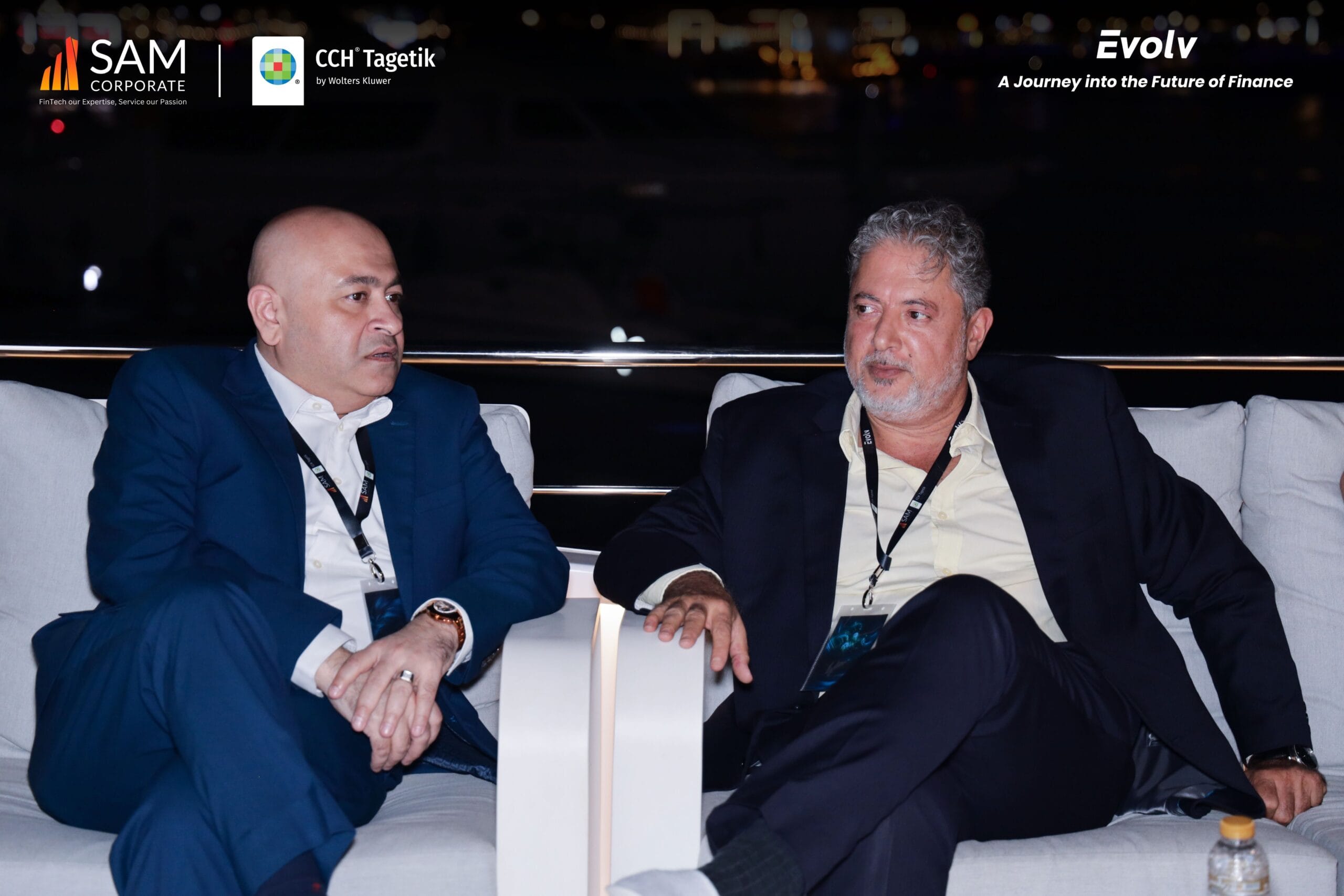Two finance executives engaging in conversation at the Evolv networking event, a partnership between SAM Corporate and CCH Tagetik.