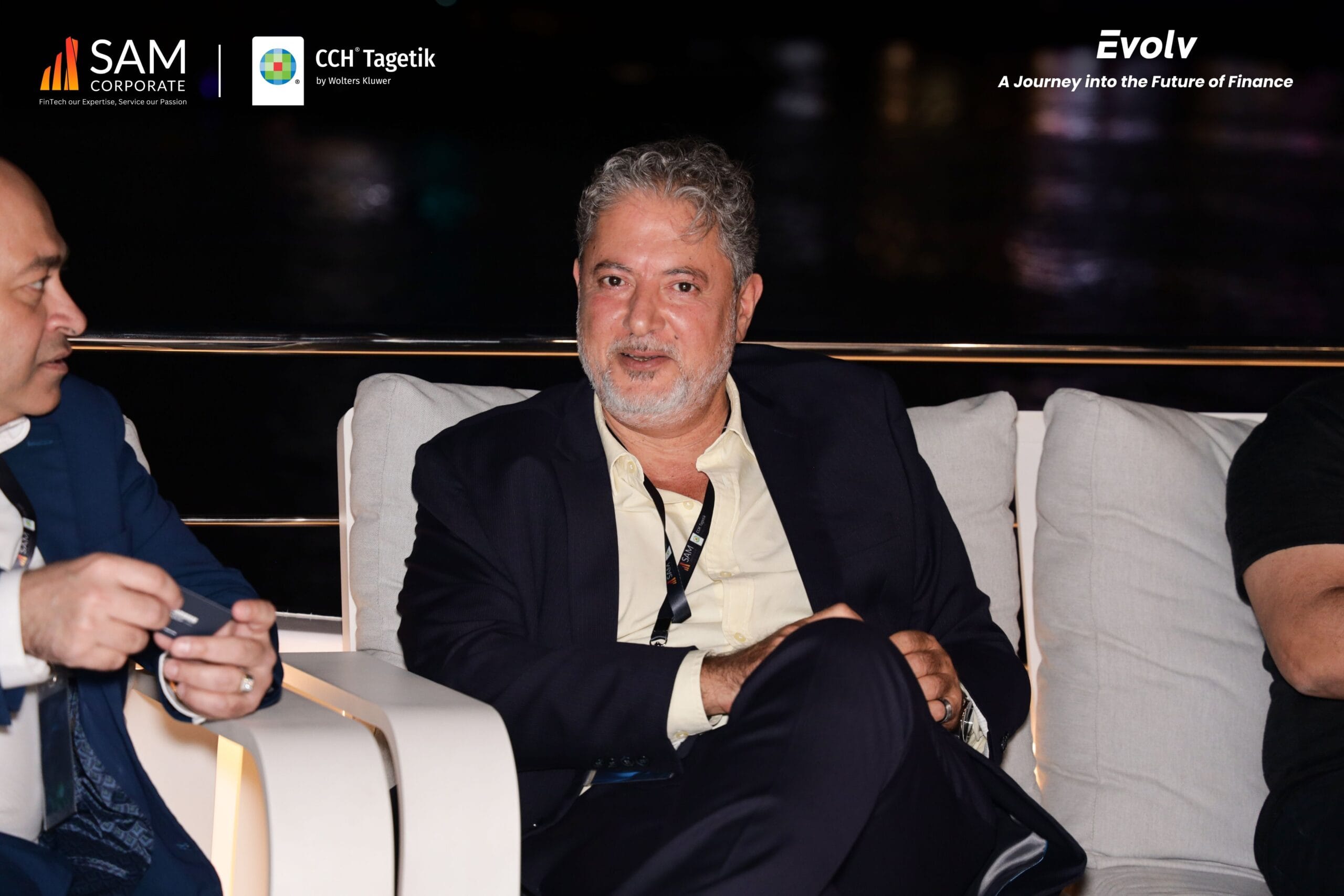 Senior executive seated and smiling at the Evolv thought leadership event hosted by SAM Corporate and CCH Tagetik.