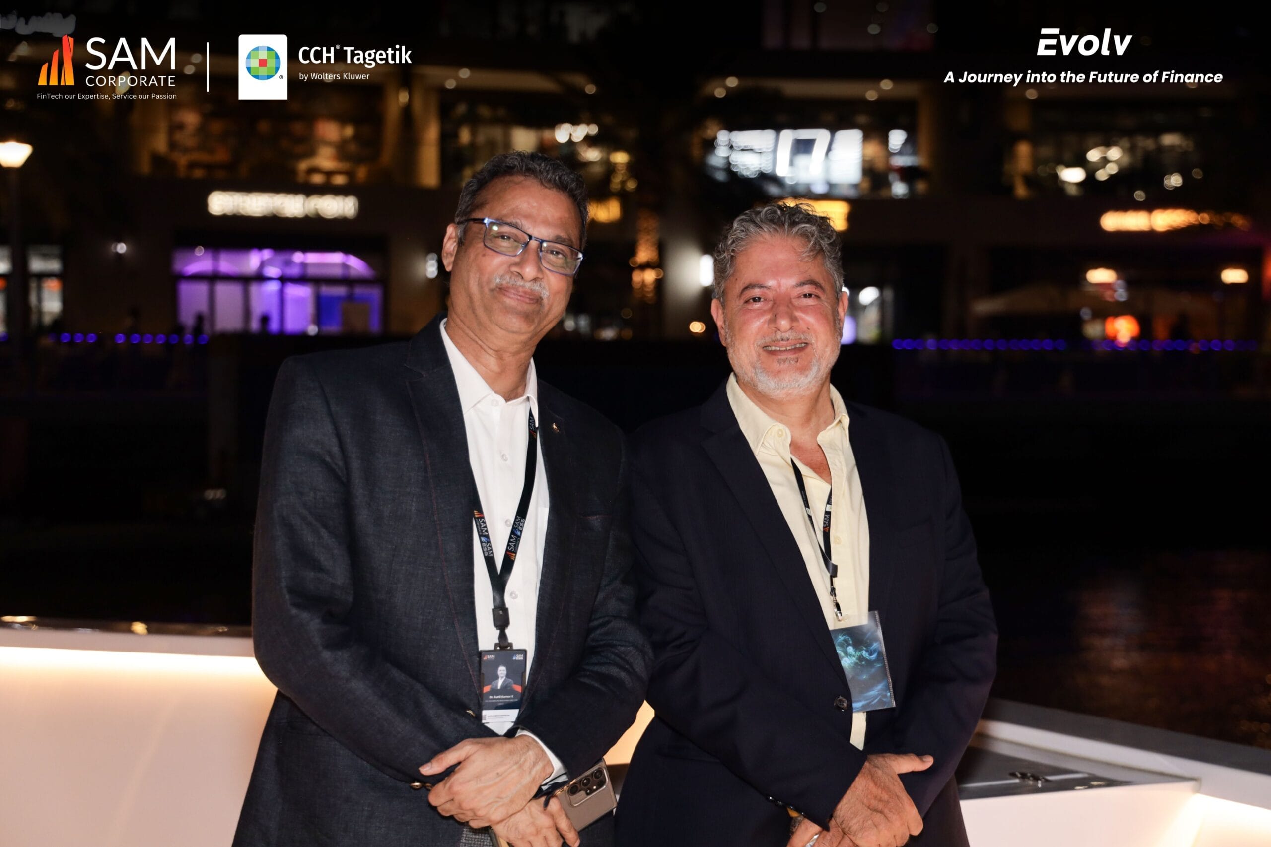 Two executives posing for a photo at the evening networking session of the Evolv event by SAM Corporate and CCH Tagetik.