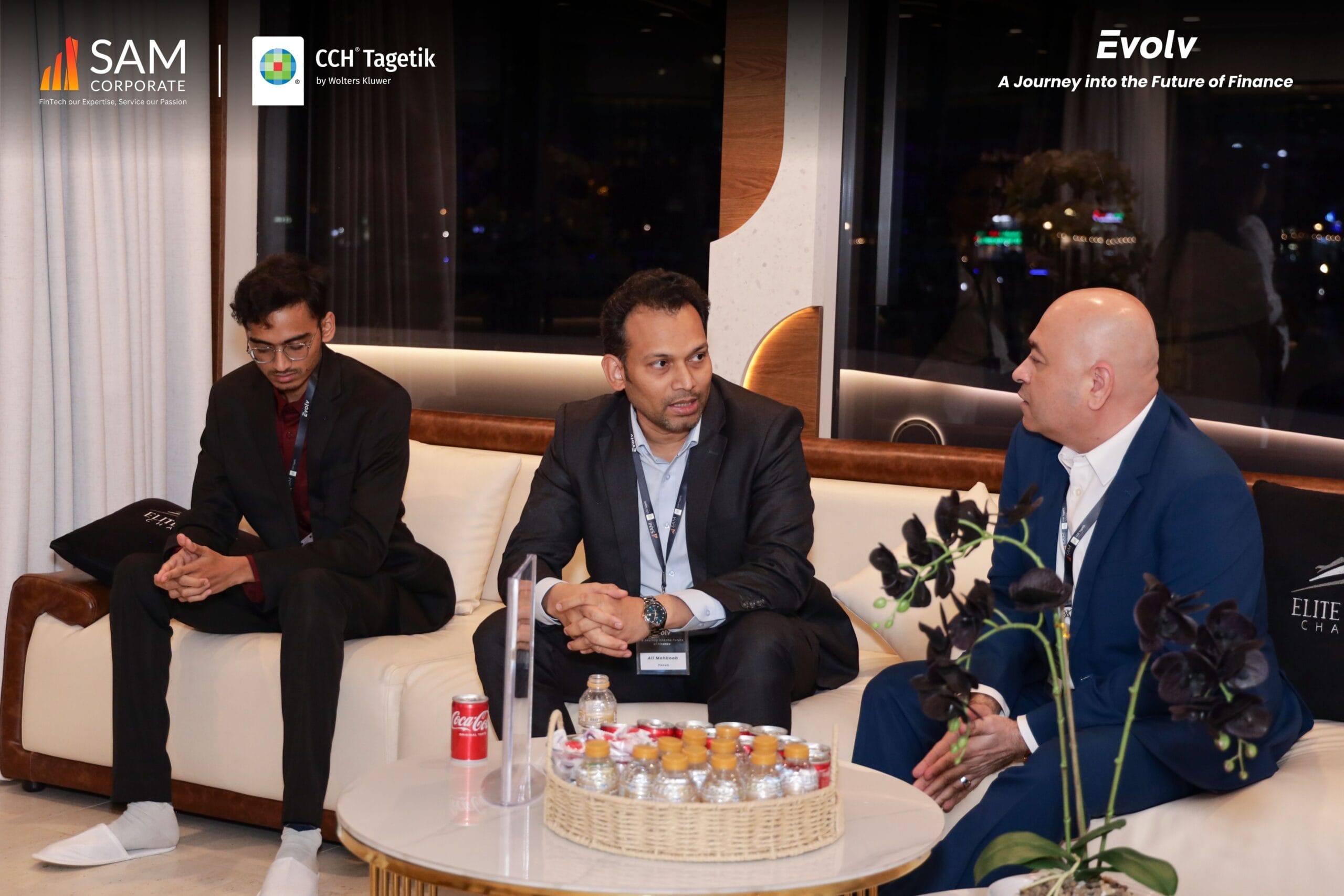 Three attendees seated and engaging in a business discussion during the Evolv event by SAM Corporate and CCH Tagetik.