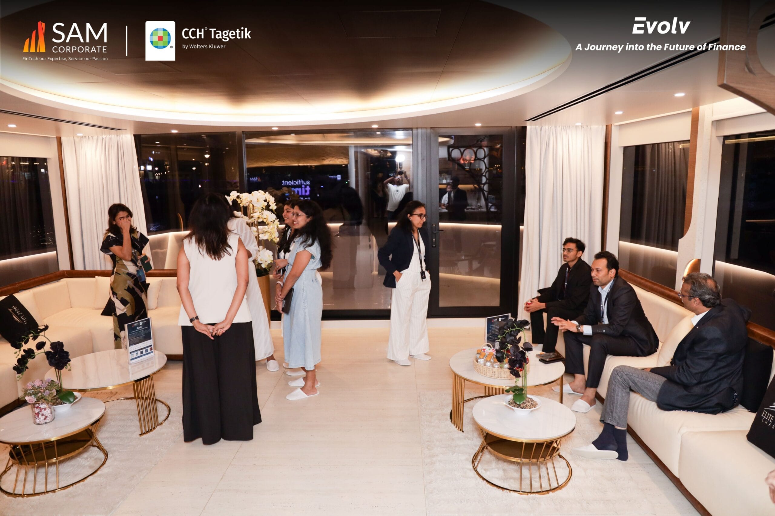Attendees networking in the luxurious lounge of the Evolv event, sponsored by SAM Corporate and CCH Tagetik.