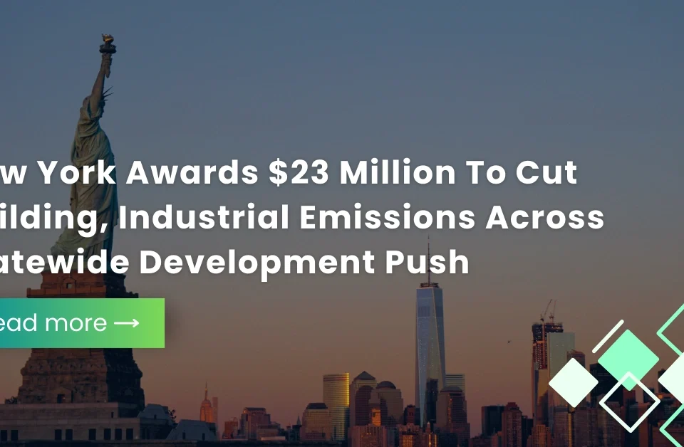 Statue of Liberty and New York City skyline at dusk with text overlay regarding a $23 million award to cut building and industrial emissions.