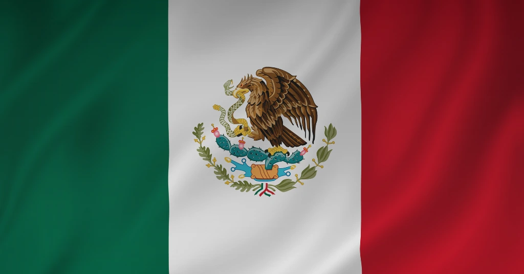 A close-up, high-resolution view of the national flag of Mexico showing the green, white, and red vertical stripes with the national coat of arms.