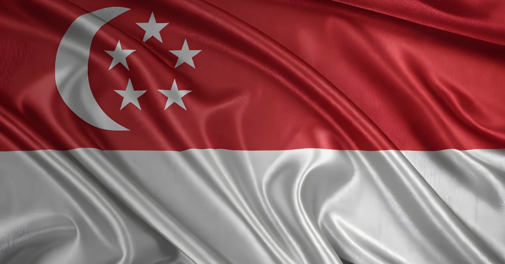 A waving Singapore national flag showing the red and white horizontal sections with the crescent moon and five stars in the upper left.