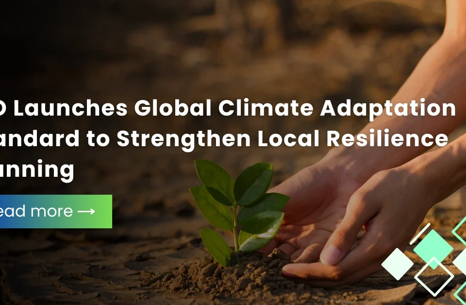 Hands planting a small green sprout in dry, cracked earth with a headline about the ISO launching a global climate adaptation standard to strengthen local resilience planning.