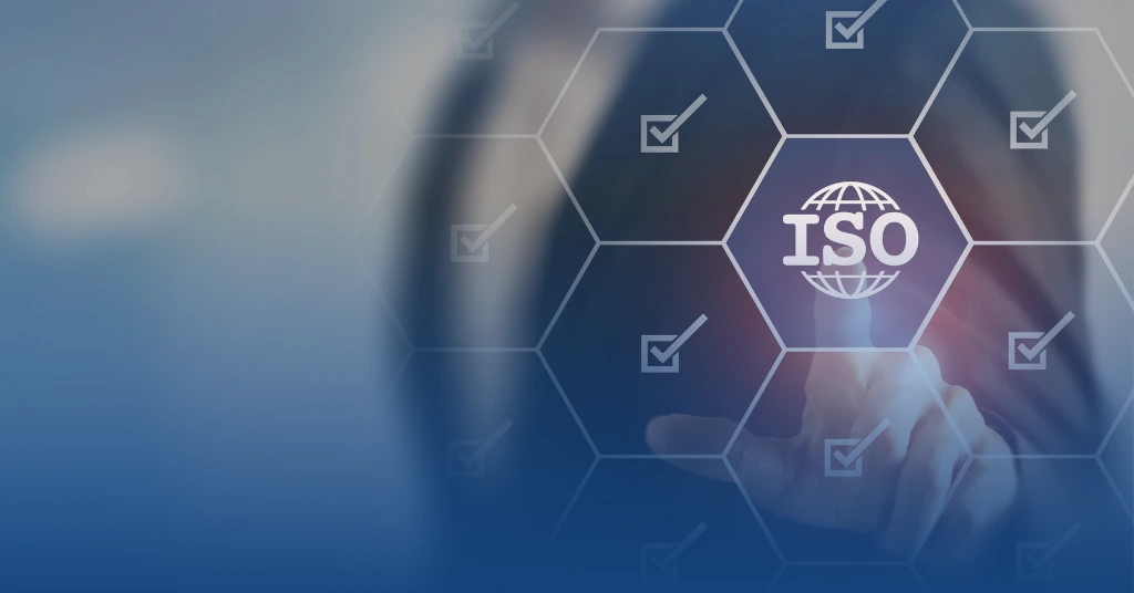 A person’s finger touching a digital ISO logo within a hexagonal grid of checkmark icons, symbolizing international standards and compliance.
