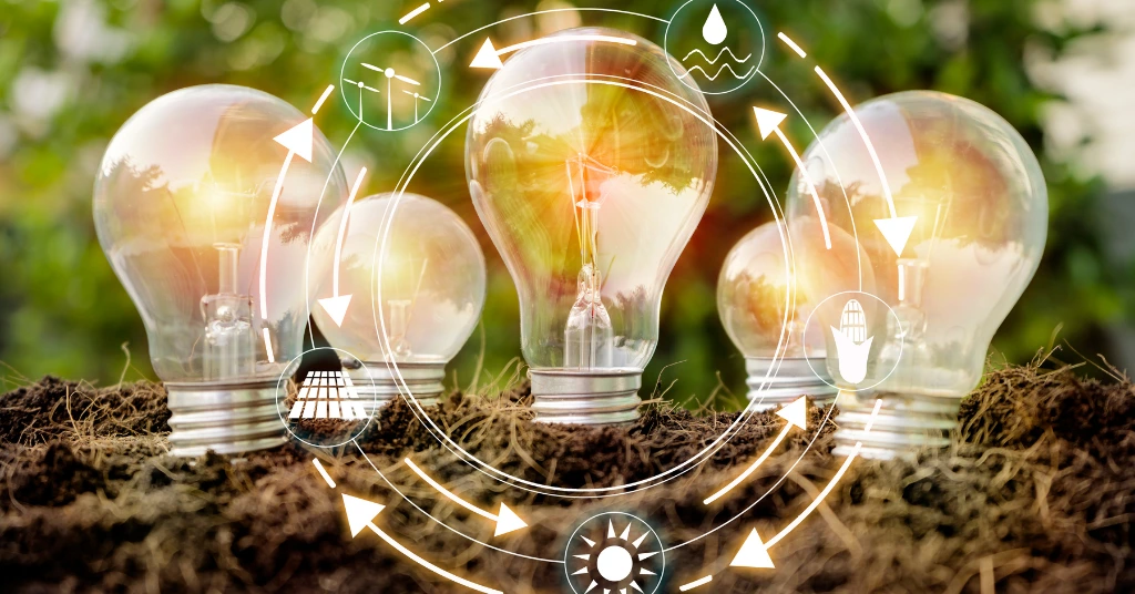 Light bulbs growing out of soil with digital icons for solar, wind, and water power, representing renewable energy cycles and green innovation.